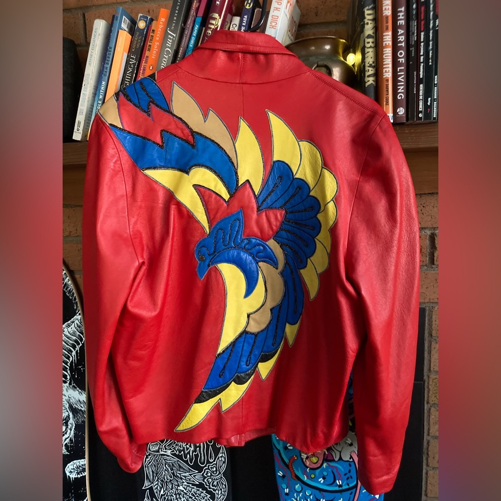 vintage leather jacket with patchwork on the back/shoulder. missing button.